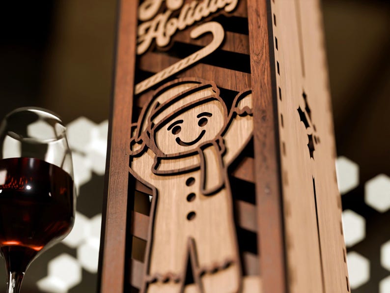May include: Wooden wine bottle holder with a gingerbread man design. The holder has a light brown finish with a dark brown accent. The words "Happy Holidays" are carved at the top. A wine glass with red wine is in the foreground.