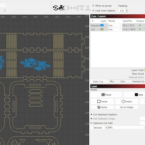 May include: A computer screen displaying a laser cutting software interface. The interface shows a design with two floral patterns and a grid pattern. The design is ready to be cut with a laser cutter.