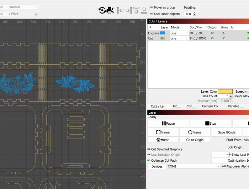 May include: A computer screen displaying a laser cutting software interface. The interface shows a design with two floral patterns and a grid pattern. The design is ready to be cut with a laser cutter.