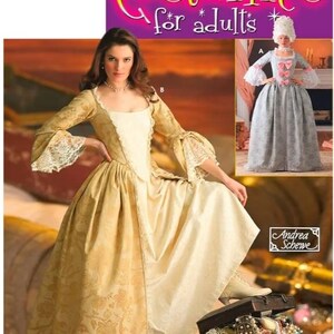 May include: Simplicity Costumes for Adults pattern. The image features a woman in a gold and cream-colored historical dress with lace sleeves. A smaller image shows a gray dress with pink bows. The pattern includes the text "Andrea Schewe" and "Wrights".