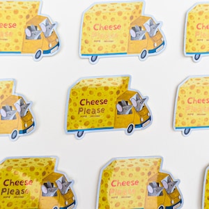 May include: A set of stickers depicting a yellow truck with a cheese-shaped cargo area. The truck has a cartoon mouse driver and the text "Cheese Please Home Delivery". The stickers are on a white background.