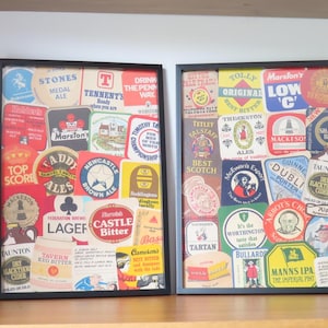 May include: Two framed vintage advertisements for different brands of beer. The advertisements are made up of a collage of colorful labels with text and images. The frames are black and the background is white.
