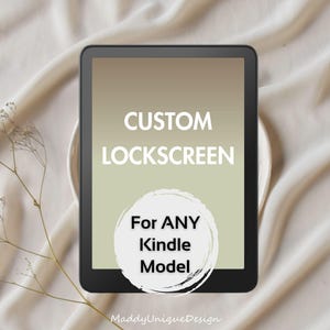 May include: A black Kindle device displays a custom lockscreen with the text "CUSTOM LOCKSCREEN" and "For ANY Kindle Model" in a white circle. The background is a gradient of beige and light green. The device rests on a white plate and a beige fabric.