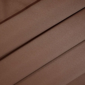 May include: A close-up of a smooth, brown fabric with a subtle sheen. The fabric has a slightly textured surface.