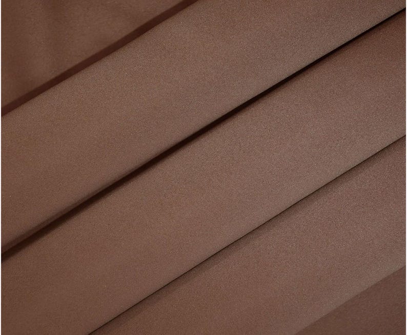 May include: A close-up of a smooth, brown fabric with a subtle sheen. The fabric has a slightly textured surface.