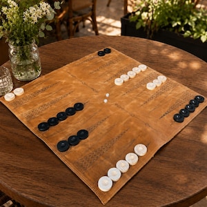 Handmade leather backgammon set with laser engraved playing surface and premium stitching.