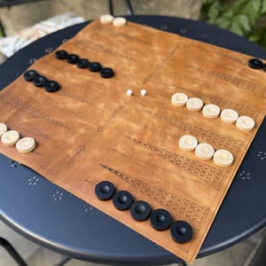 Luxury board game crafted from genuine leather including checkers and dice.