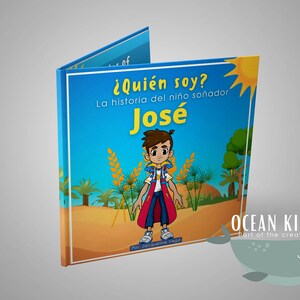 May include: A blue and yellow book cover with the title "¿Quién soy?" and the text "La historia del niño soñador José" in Spanish. The cover features a cartoon illustration of a boy wearing a blue shirt, red cape, and a backpack. The book is published by Ocean Kids.