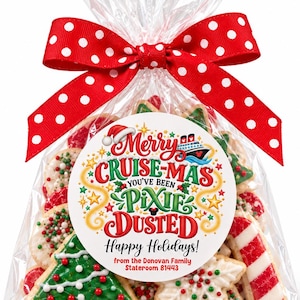 May include: A clear plastic bag filled with assorted holiday cookies, tied with a red ribbon featuring white polka dots. A circular label on the front reads Merry CRUISE-MAS YOU'VE BEEN PIXIE DUSTED Happy Holidays! from the Donovan Family Stateroom 81443.