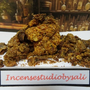 May include: A close-up of a pile of brown and yellow resinous incense. The incense is labelled "Incensestudiobysali".