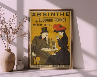 May include: A framed vintage-style poster featuring the text ABSINTHE EXTRA-SUPÉRIEURE J. ÉDOUARD PERNOT SOCIÉTÉ ANONYME MONTBÉLIARD. The illustration depicts a person in a top hat and a person in a dark dress sitting at a table with bottles.