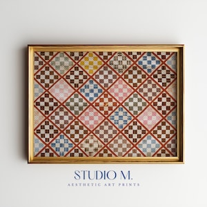 May include: A framed art print featuring a repeating diamond pattern composed of small, multi-colored checkered squares in shades of blue, pink, yellow, and brown, separated by thin red lines. The text STUDIO M. AESTHETIC ART PRINTS appears below.