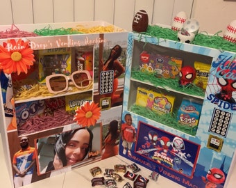May include: Two DIY vending machines decorated for Easter. The left machine is decorated with a floral theme and has a picture of a woman on the front. The right machine is decorated with a Spiderman theme and has a picture of a boy on the front. Both machines have shelves filled with sweets and other treats.