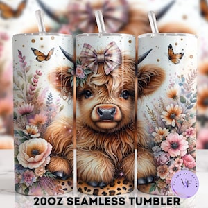 May include: A 20oz stainless steel tumbler with a design of a Highland cow with a pink bow, surrounded by pink and white flowers and butterflies. The tumbler has a white background with gold glitter accents.