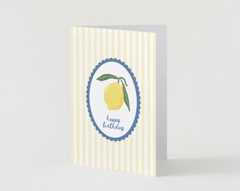 May include: A yellow lemon with green leaves in a blue and white circle with the text "happy birthday" on a yellow and white striped background.