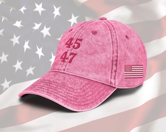 May include: Pink baseball cap with the numbers 45 and 47 embroidered on the front and a small American flag patch on the side.