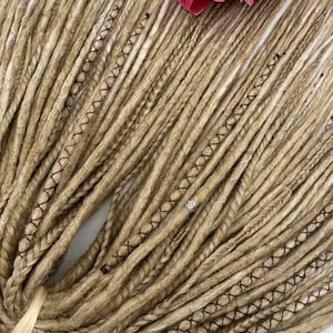 These are synthetic blonde dreads and braids. This set can be in two versions: double ended and single ended dreadlocks, or as they are called for short - DE and SE. This handmade set is made of absolutely safe synthetic material - Kanekalon.