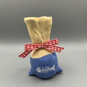 Handmade ceramic dead fish in a bag vase