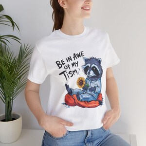 Whimsical Raccoon Tee, Fun Animal Graphic Shirt, Be in Awe of My Tism? Apparel, Gift for Kids & Adults, Casual Wear, Fun Austism Tee