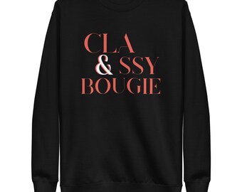May include: Black sweatshirt with the text "CLA & SSY BOUIGIE" in coral and white lettering. The sweatshirt has a crew neck and long sleeves. The text is centered on the front of the garment.