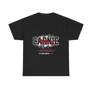 May include: Black t-shirt with the text "CARNIE Midway UNIVERSITY" in white and red lettering. The design includes a grunge-style background and additional text and symbols below the main text.