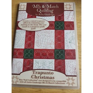 May include: A DVD case titled Mix & Match Quilting by Anita Goodesign Trapunto Christmas. The cover features a grid of red and green squares with white line art of holiday motifs like stockings, snowmen, and bows on a white background.