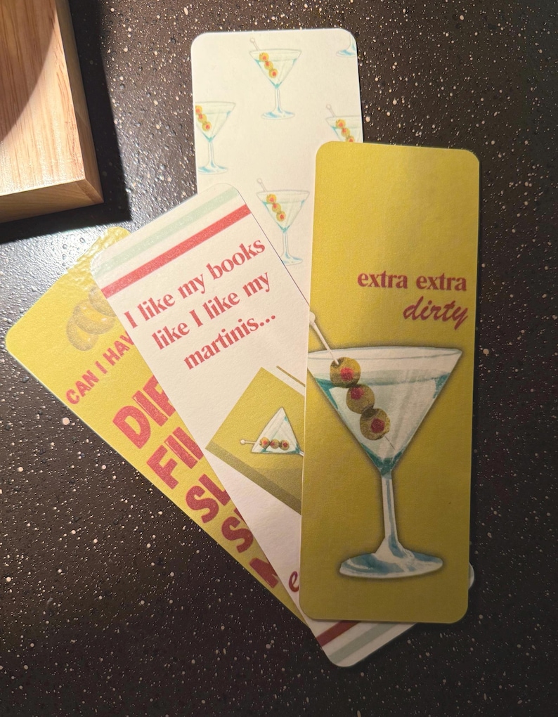 May include: Three yellow and white bookmark cards with a martini glass design. The text on the cards reads "Can I have", "I like my books like I like my martinis...", and "extra extra dirty".