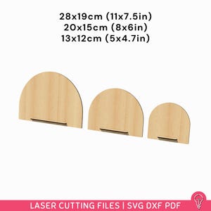 May include: Three wooden arch-shaped laser-cut files in varying sizes: 28x19cm, 20x15cm, and 13x12cm. Each has a rectangular base. The text "LASER CUTTING FILES | SVG DXF PDF" is at the bottom.