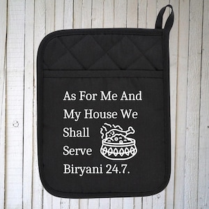 May include: Black quilted oven mitt with white text that reads "As For Me And My House We Shall Serve Biryani 24.7."  A white illustration of a bowl of biryani is included.