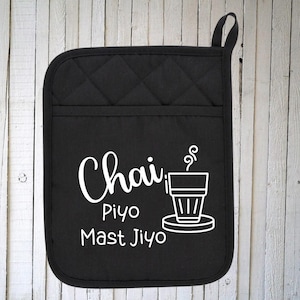 May include: Black quilted pot holder with white text that reads "Chai Piyo Mast Jiyo" and a graphic of a cup of tea with steam rising from it.