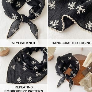 May include: A black triangular scarf featuring a white repeating floral embroidery pattern and a scalloped cream-colored lace edge. The scarf is shown tied in a knot, displayed flat, and folded, highlighting the textured fabric and detailed stitching.