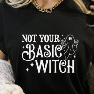 May include: Black t-shirt with a white graphic that says "Not Your Basic Witch" with a ghost illustration.