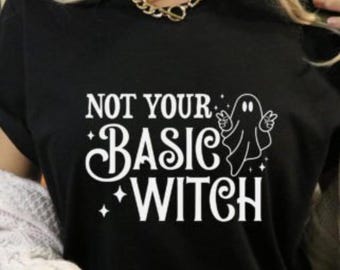 May include: Black t-shirt with a white graphic that says "Not Your Basic Witch" with a ghost illustration.