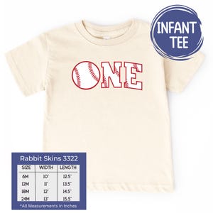 May include: A beige infant tee shirt with a red baseball and the word "ONE" in red letters. The shirt has a size chart with measurements in inches.