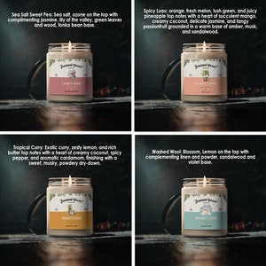 May include: Four glass jar candles with lit wicks. Each candle has a label with the "Stardew Valley Brand" logo and a unique scent name: Sea Salt Sweet Pea, Spicy Luau, Tropical Curry, and Washed Wool. The candles are on a dark surface.
