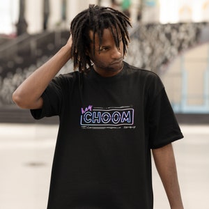 A man outside wearing a black Cyberpunk 2077 Hey Choom Unisex Oversized T-Shirt by New Save.