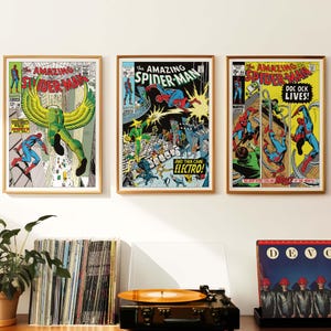 May include: Three framed comic book covers featuring Spider-Man. The covers are in a vintage style with bright colours and bold lettering. The first cover features Spider-Man battling a green-skinned villain with yellow wings. The second cover features Spider-Man battling Electro. The third cover features Spider-Man battling Doc Ock.