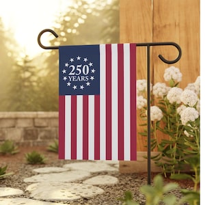 May include: A rectangular garden flag featuring a blue canton with a circle of thirteen white stars surrounding the white text 250 YEARS. The flag has vertical red and white stripes and is displayed on a black metal garden flag stand.