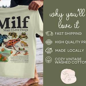 May include: Cream-colored t-shirt with the text "Milf: Man I Love Frogs" in black. The shirt features a colorful graphic of various frog species. The shirt is made of cozy vintage washed cotton.