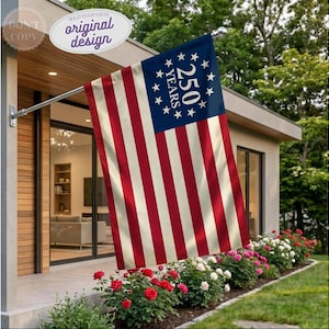 May include: A rectangular flag featuring thirteen alternating red and off-white horizontal stripes. The blue canton displays a circular arrangement of thirteen white stars surrounding the text 250 YEARS in a bold, white, serif font.