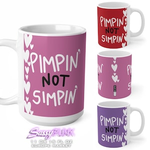 May include: Set of three 11 or 15 ounce ceramic mugs with white handles. The mugs feature a pink, red, and purple background with white hearts and the text "Pimpin' Not Simpin'" in white.