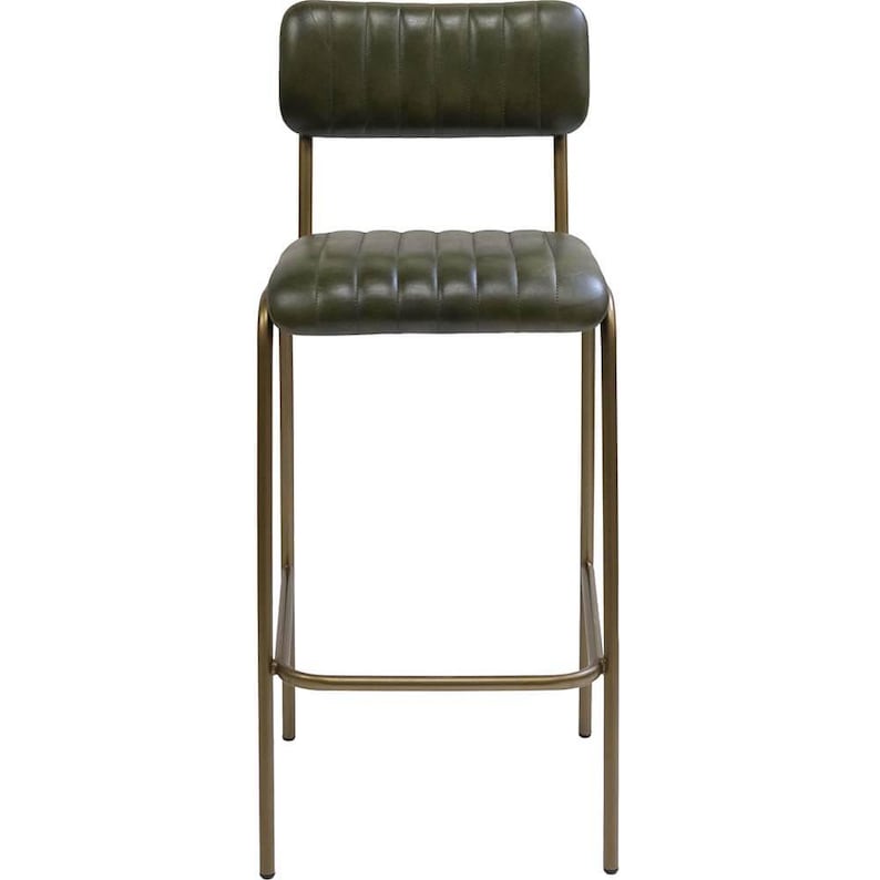 May include: A tall bar stool with a dark olive green seat and backrest. The seat and backrest have a quilted design. The frame is made of a gold-colored metal. The stool has a footrest and a straight back.