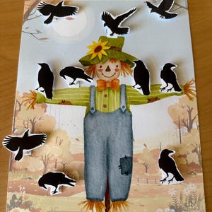 May include: A children's educational game featuring a scarecrow illustration with ten black crow cutouts. The game board has the text "Count 10 Crows" at the top, with a fall-themed background.