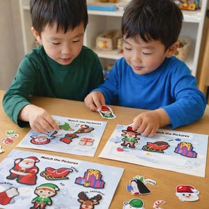 May include: Two children are playing with Christmas-themed matching picture cards on a wooden table. The cards feature images of Santa Claus, elves, reindeer, and other holiday elements. The text "Match the Pictures" is visible on the cards.