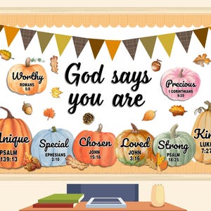 May include: A framed print with a fall theme. The words "God says you are" are in the center, with colorful pumpkins and text like "Unique," "Special," and "Kind." The background is a light orange with a scalloped border.