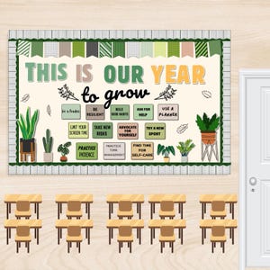 May include: A classroom display board with the words "THIS IS OUR YEAR to grow" and motivational phrases. The board is decorated with green and white accents, and potted plants. Below are rows of desks and chairs.