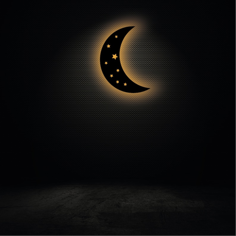 May include: A black crescent moon with stars cut out of it, illuminated with a warm yellow glow, against a dark textured background.
