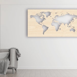 May include: A light wood wall decor featuring a world map cutout. The map is a light gray color and is set against a light wood background. The decor is hanging on a white wall in a living room setting.