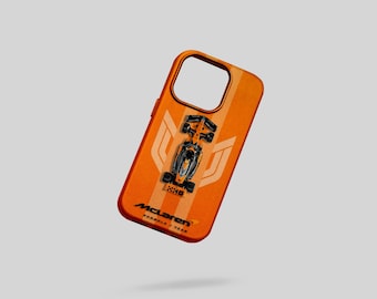 May include: Orange phone case featuring a Formula 1 race car design. The case has a vertical stripe pattern and the McLaren Formula 1 Team logo. The phone case is designed to fit a smartphone.