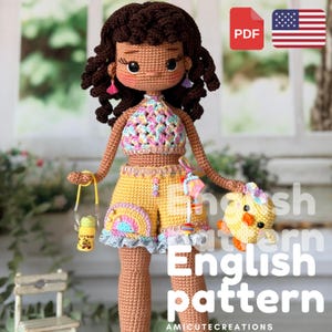 May include: A crocheted doll with dark brown curly hair, wearing a multicoloured pastel halter top and yellow shorts with a rainbow patch. The doll holds a small yellow bottle and a yellow chick toy, featuring pink and purple tassel earrings.